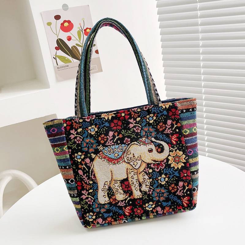 Black tote bag with a colourful floral embroidered elephant