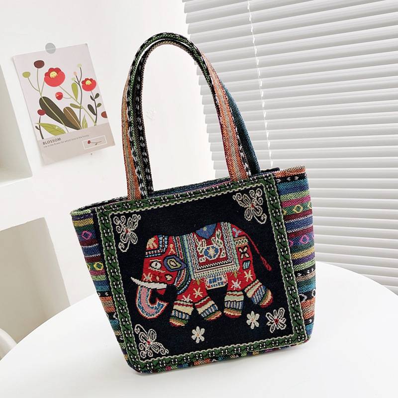 Black boho tote bag with a red-saddled embroidered elephant and colourful trim