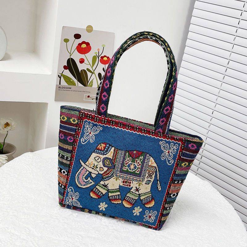 Navy tote bag with a blue-toned embroidered elephant