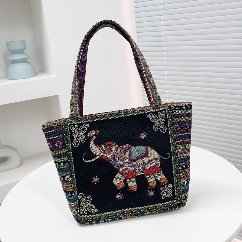 Cream tote bag with a blue embroidered elephant