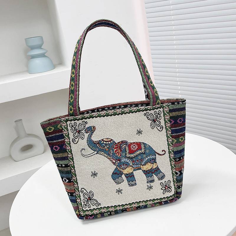 Cream and tan tote bag with a blue elephant and striped trim