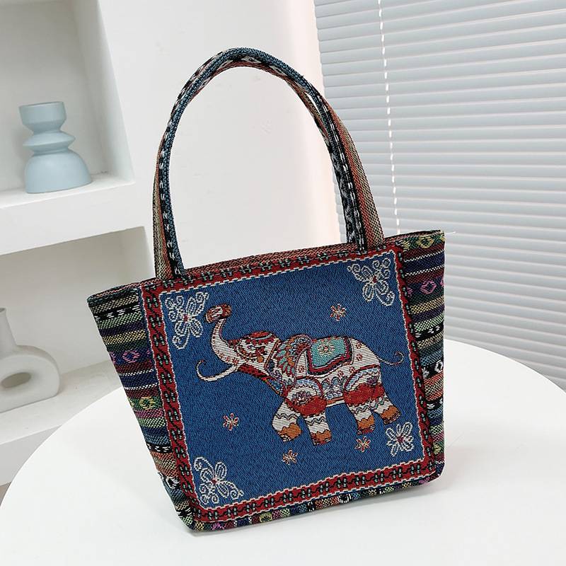 Navy blue tote bag with an embroidered elephant motif