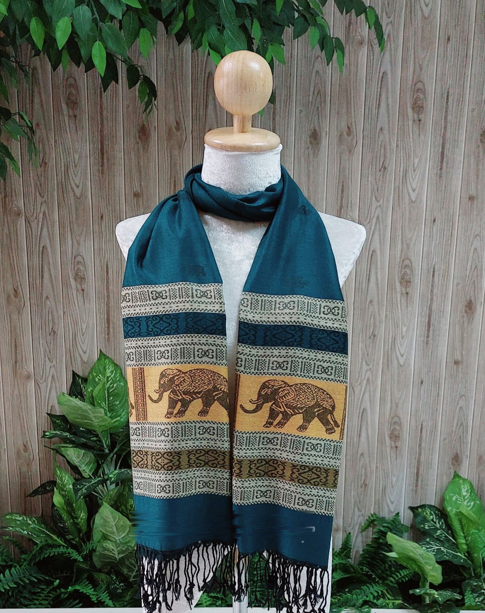 Elephant silk shawl in deep teal on a mannequin